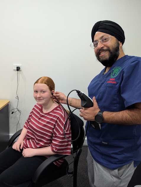 Earport Audiology clinician carrying out specialised clinical hearing testing on a young patient using audiology equipment
